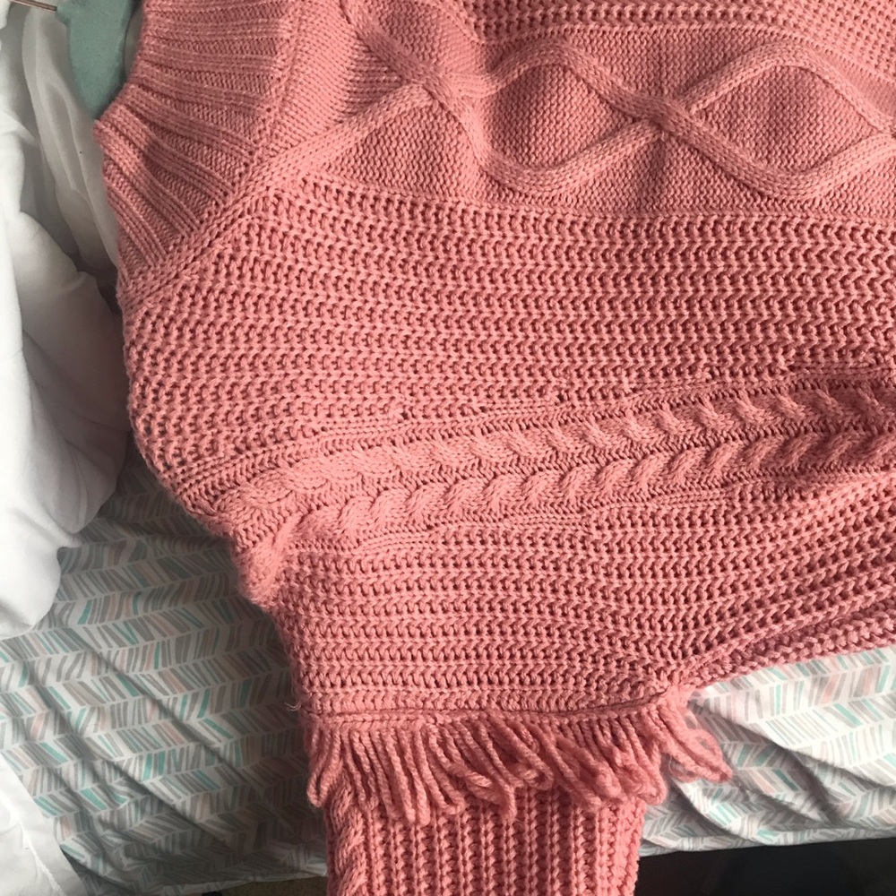 pink knitted sweater w fringe detail on sleeves
